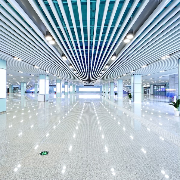 White mall interior with bright overhead lights